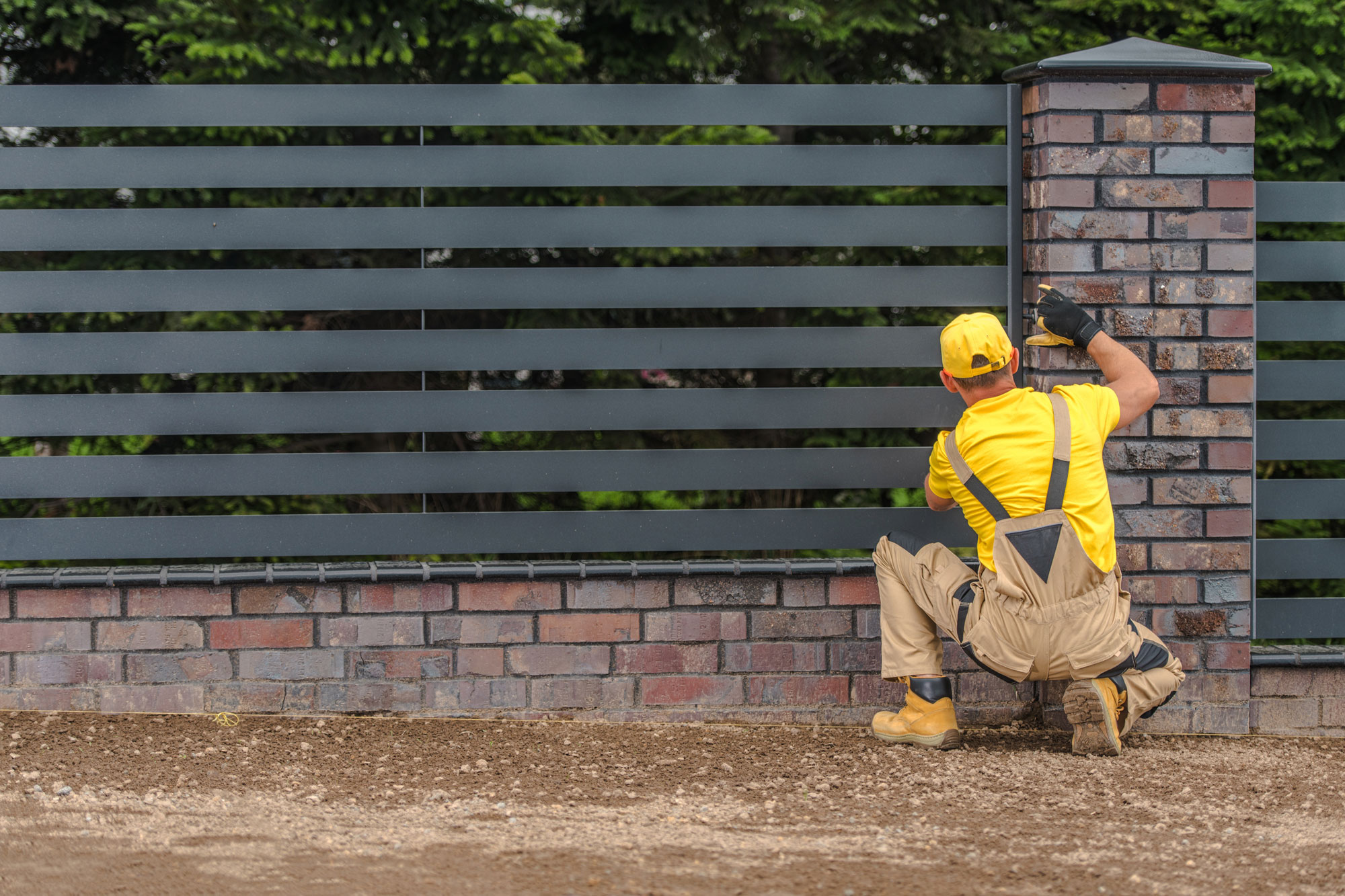 Man installing metal fences